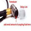Add coupling fluid to transducer before attaching delay line tip